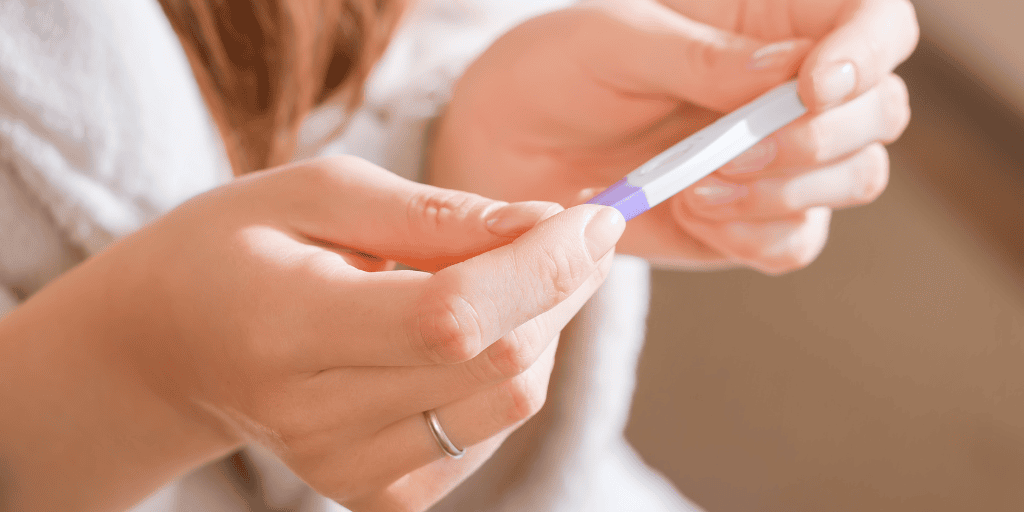 Female hands holding pregnancy test 