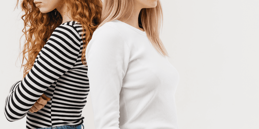 Abortion in Missouri - abortion arguments get heated easily. Two women stand back to back, indicating they are at odds with one another.