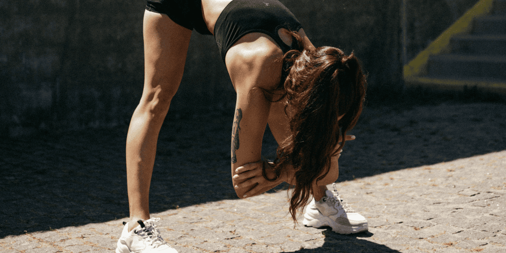 Woman in workout gear stretches for a workout